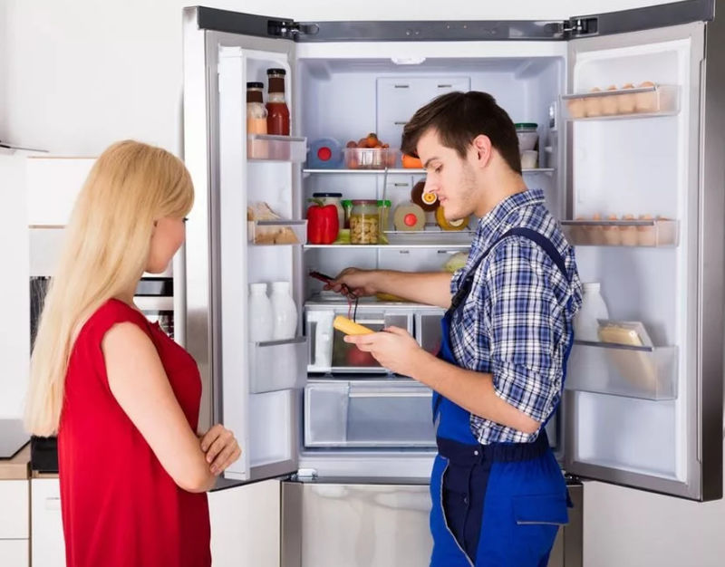 Мастер проводит диагностику холодильника